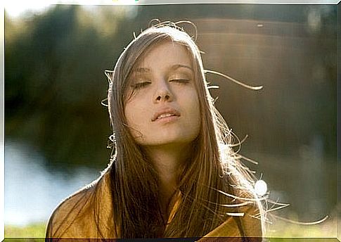 woman doing breathing exercise in nature