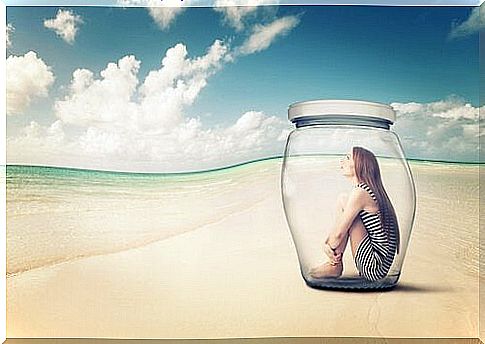 Woman with a bottle on the beach