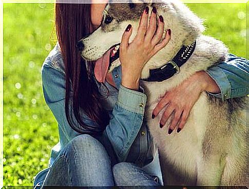 woman hugs a dog