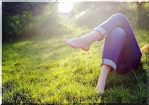 lying on the grass without shoes