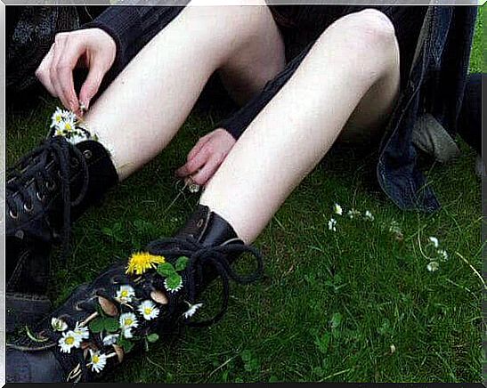 a teenager puts flowers in her boots