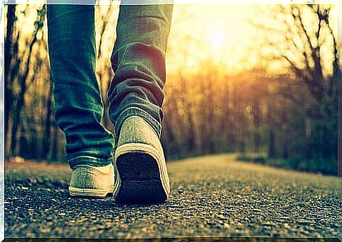 a teenager walks down the road