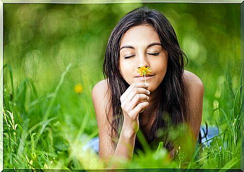 woman smelling a flower